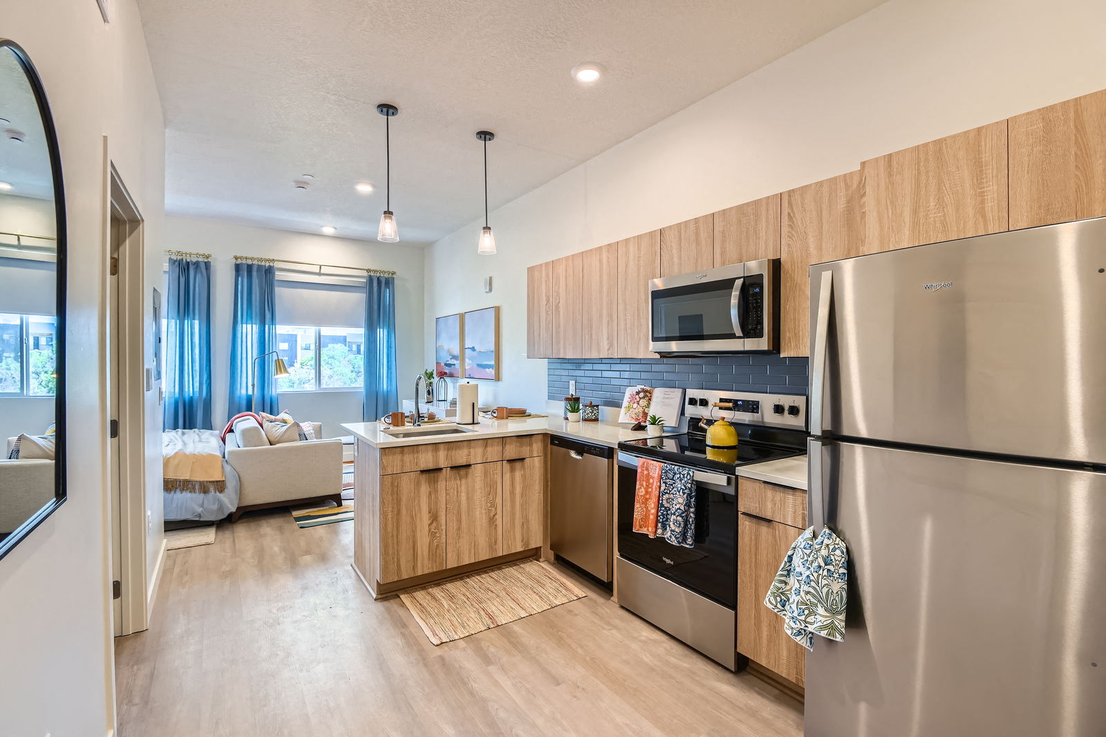 A modern kitchen with wooden cabinets and stainless steel appliances.