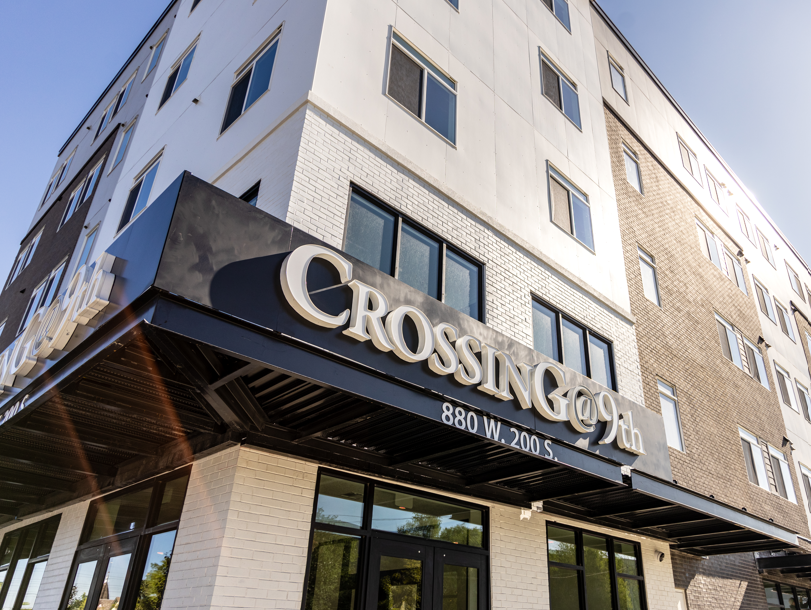 The front of a building with a sign that says "Crossing" on it.