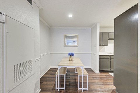 A dining room with a table and chairs.