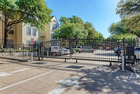 A gated entrance to a residential area with a sign that reads "EXITANCE".
