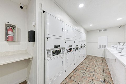 A clean, white kitchen with tile flooring and white walls.