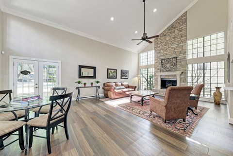 A living room with a fireplace and a glass table.