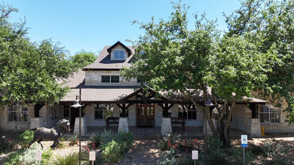 A large house with a stone facade and a large front porch.