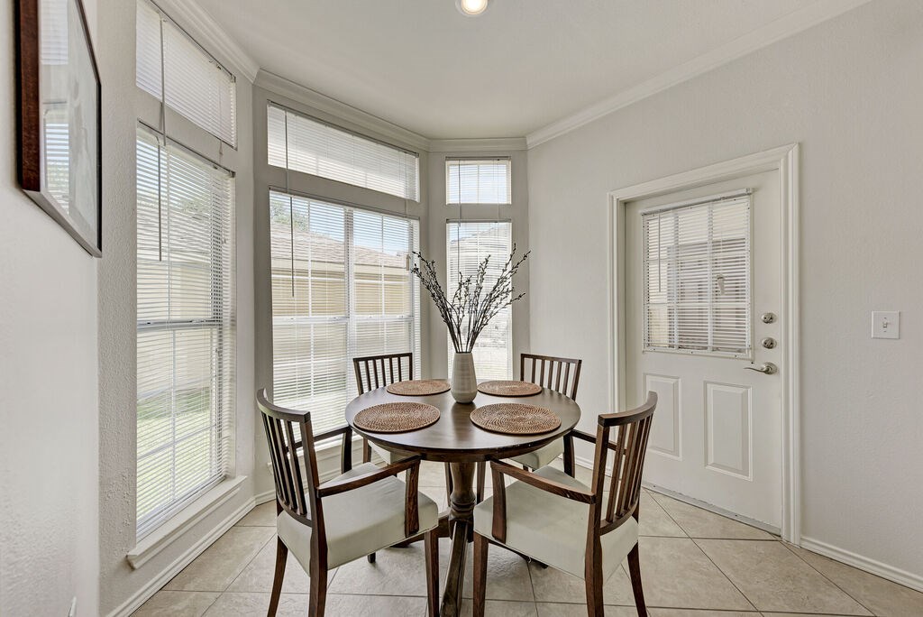 A dining room with a table set for four.