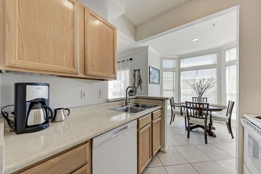 A kitchen with wooden cabinets and a white countertop.