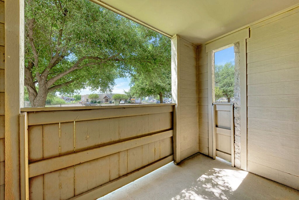 A room with a view of a tree through a window.