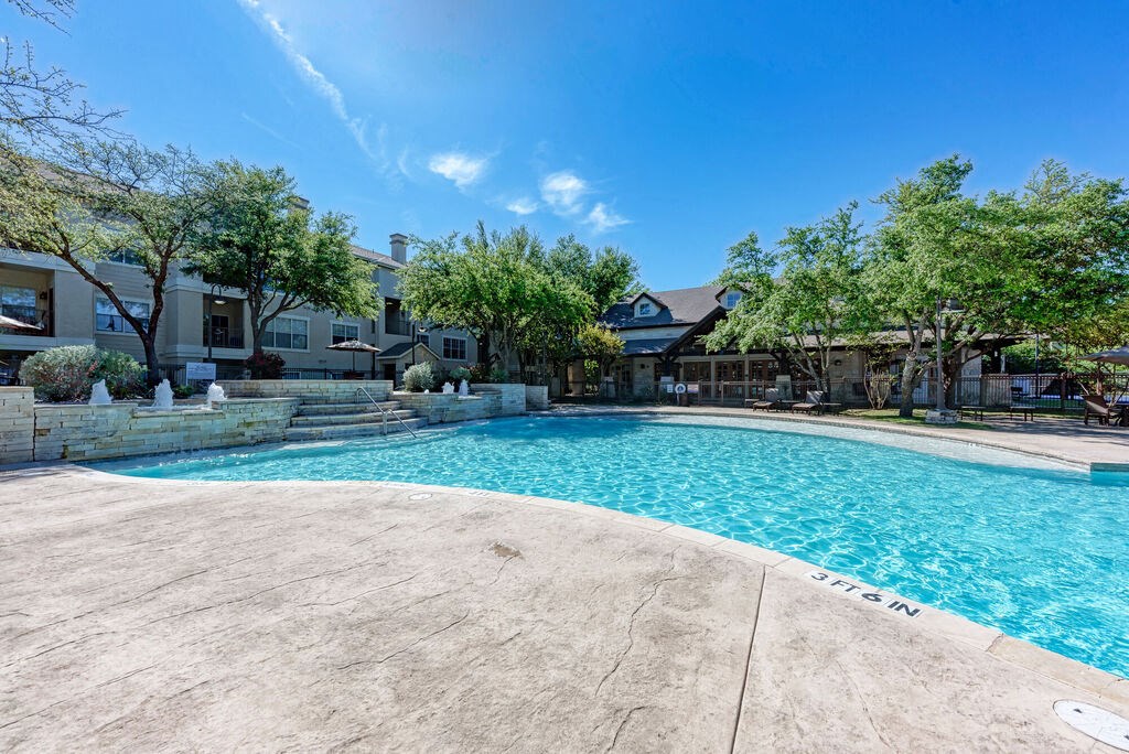 A large swimming pool with the word "JESUS" written on the side.