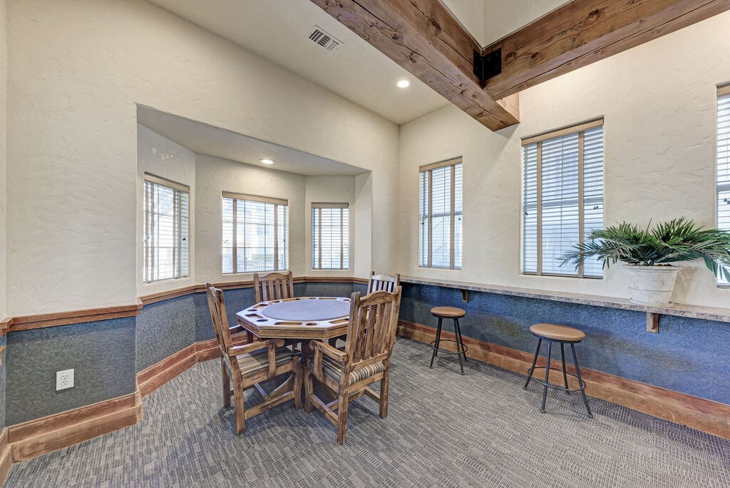 A dining room with a wooden table and chairs.