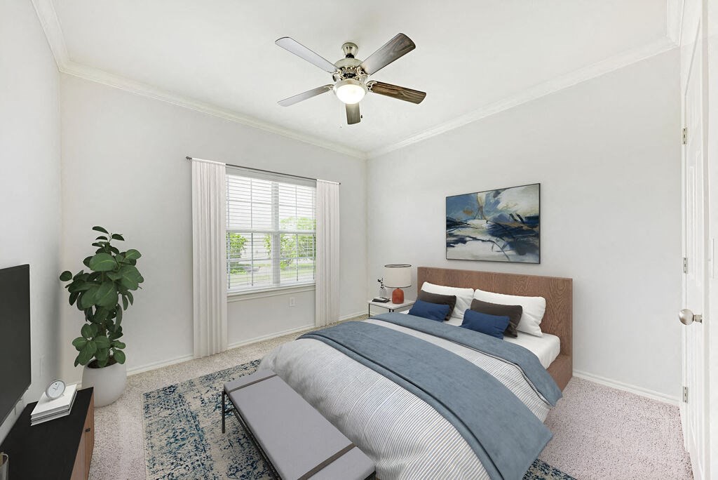 A bedroom with a bed, a ceiling fan, and a television.