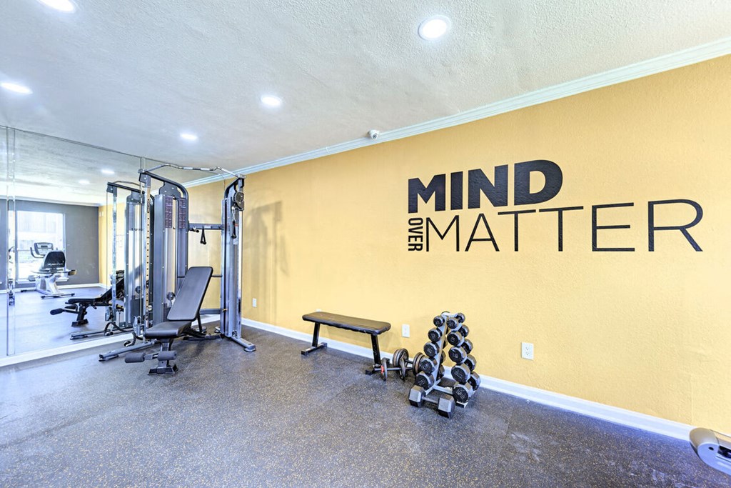 A gym with a wall that says Mind over Matter.
