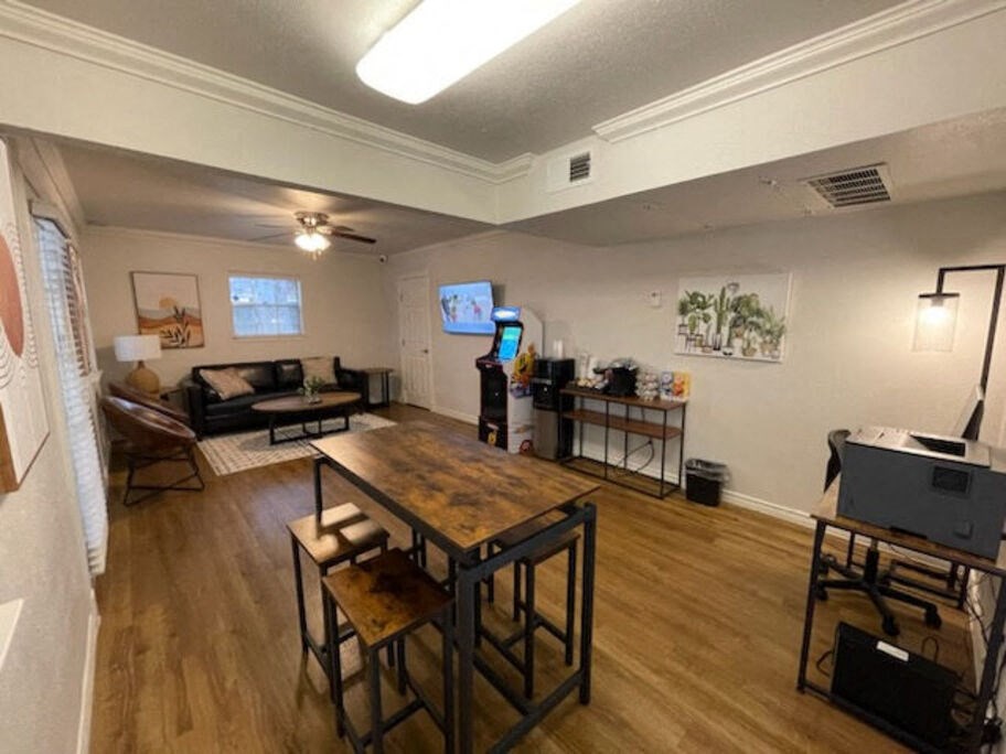 A room with a wooden table and chairs.
