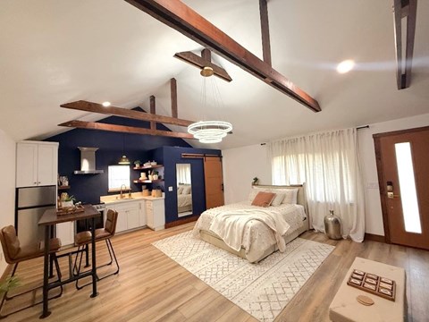 a bedroom with a bed and a ceiling fan