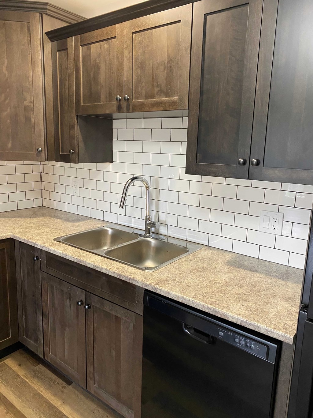 A kitchen with a sink and a dishwasher.