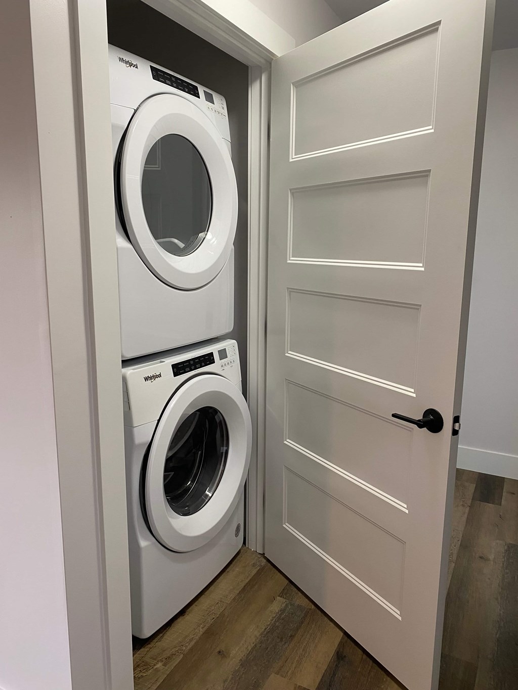 A white door with a washing machine behind it.