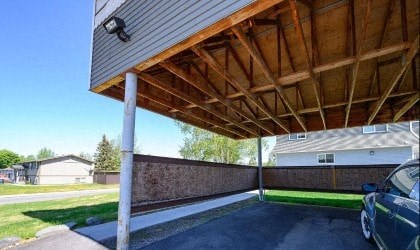 a car parked under a covered porch on a house