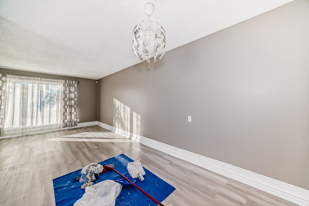 a living room with a rug on the floor and a chandelier
