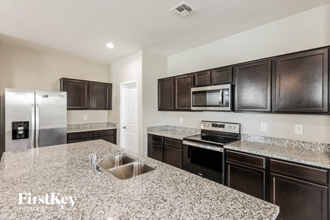 a kitchen with granite counter tops and stainless steel appliances