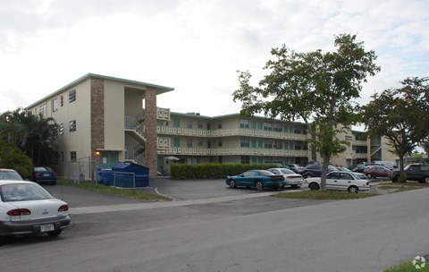a large building with cars parked in front of it