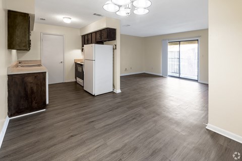 A kitchen area with a refrigerator, oven, and sink.