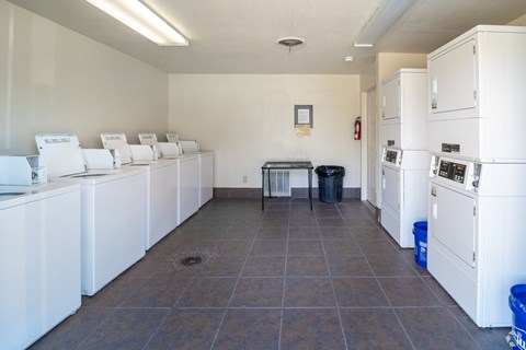 A laundry room with a washer and dryer on the wall.
