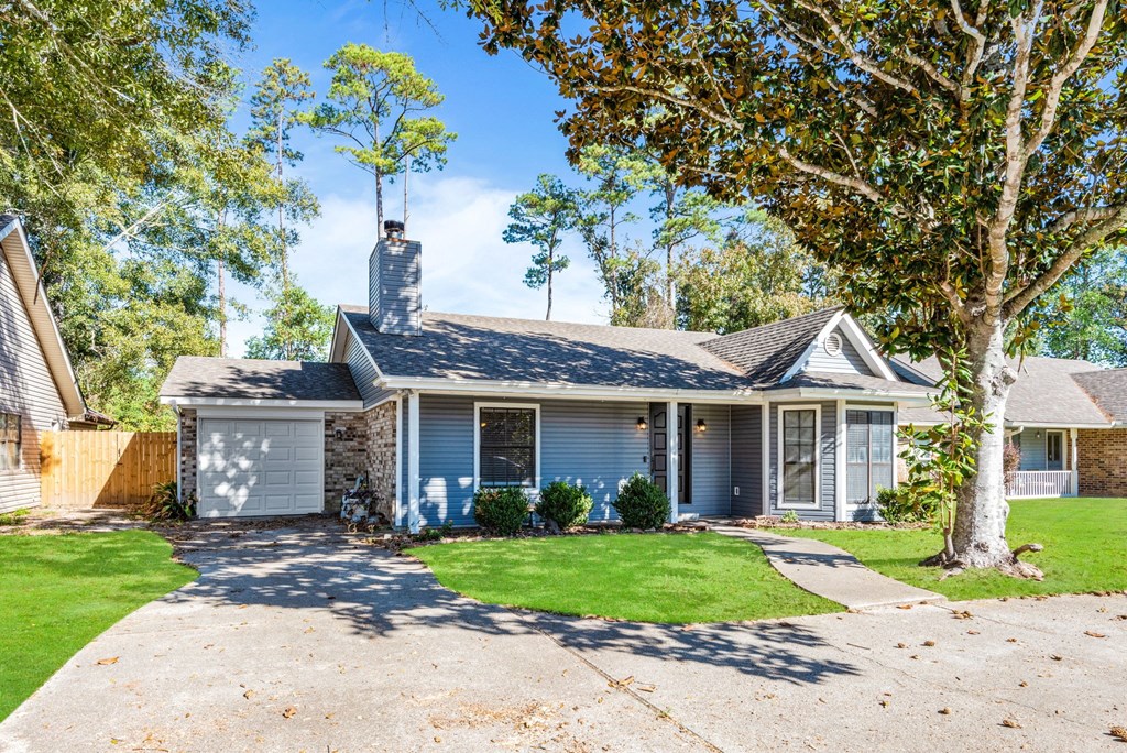 A house with a grey roof and a white garage door.