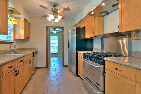 A kitchen with wooden cabinets and stainless steel appliances.