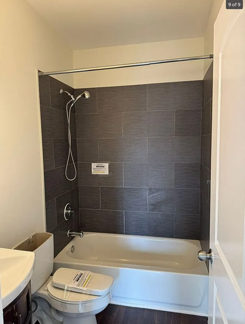 a bathroom with a toilet and a bath tub