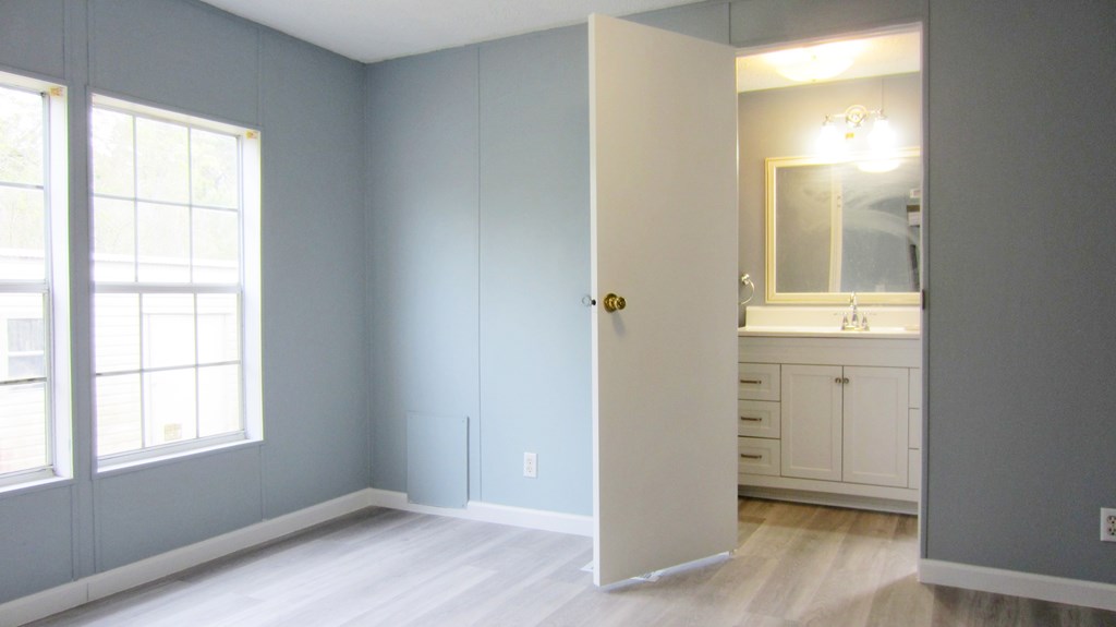 A room with a white door and a window.