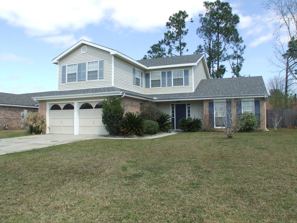 A house with a garage and a driveway.