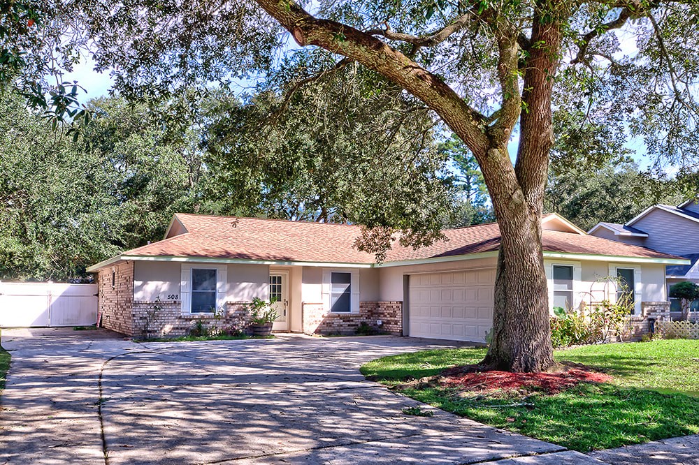 A house with a tree in front of it.