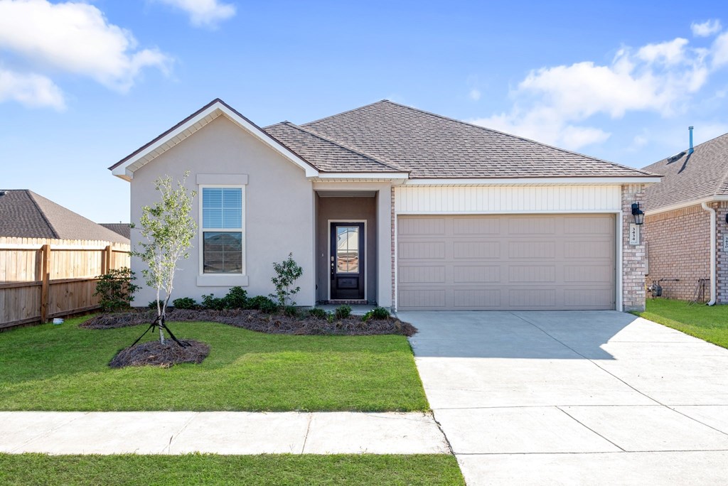 A house with a grey roof and a white garage door.