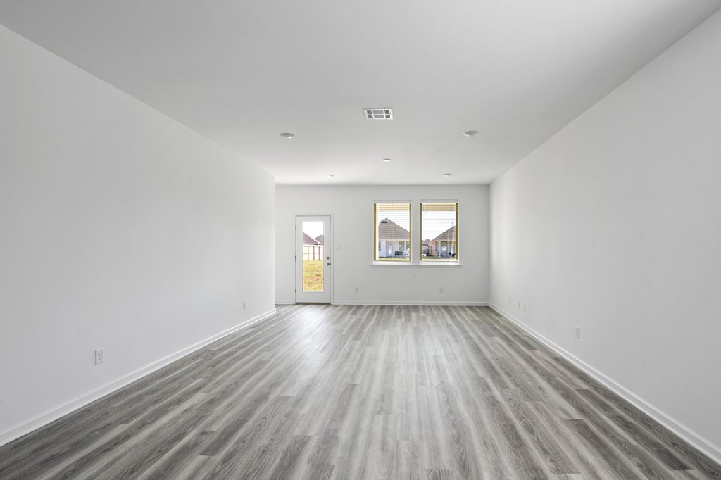 A room with a wooden floor and white walls.