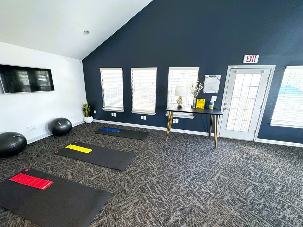 A yoga studio with mats and exercise balls.
