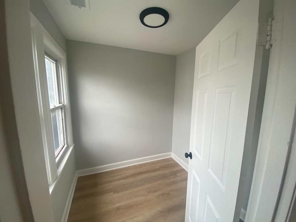 A room with a white door and a window.