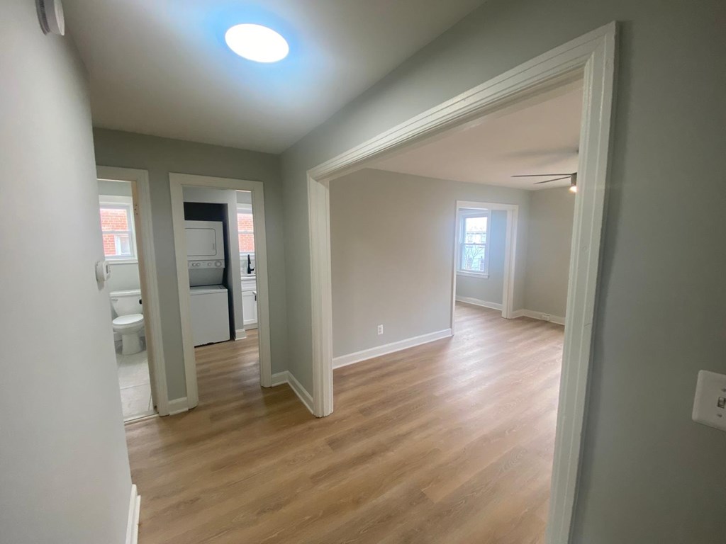 A room with a wooden floor and white walls.