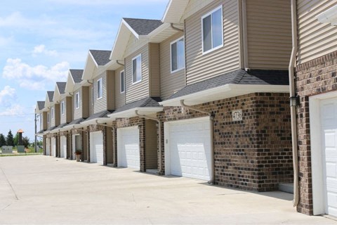 A long row of houses with garages.