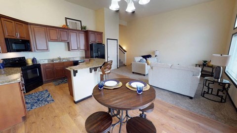 A kitchen with a table set for two.
