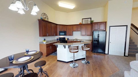 A kitchen with a table and chairs in the middle of the room.
