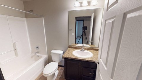 A bathroom with a white toilet and sink.