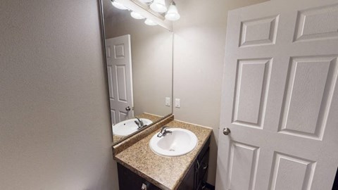 A bathroom with a sink and mirror.