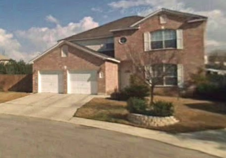 a red brick house with two garage doors