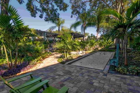 A garden with a bench and a pathway.