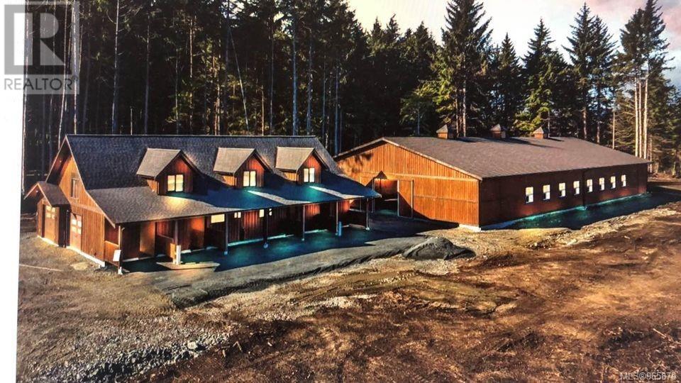 an aerial view of a house in the woods