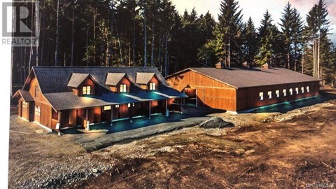 an aerial view of a house in the woods