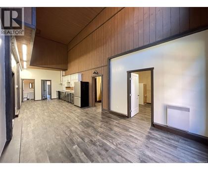 an empty living room with an island in the middle