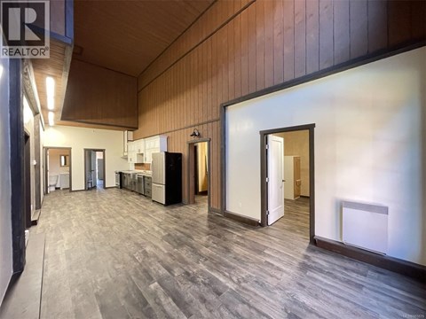 an empty living room with an island in the middle