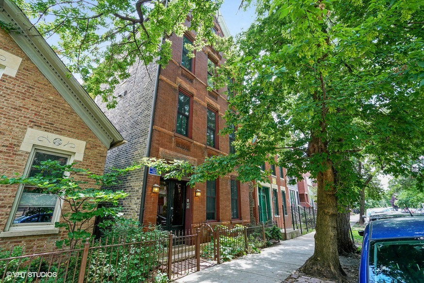 a brick building with a tree in front of it