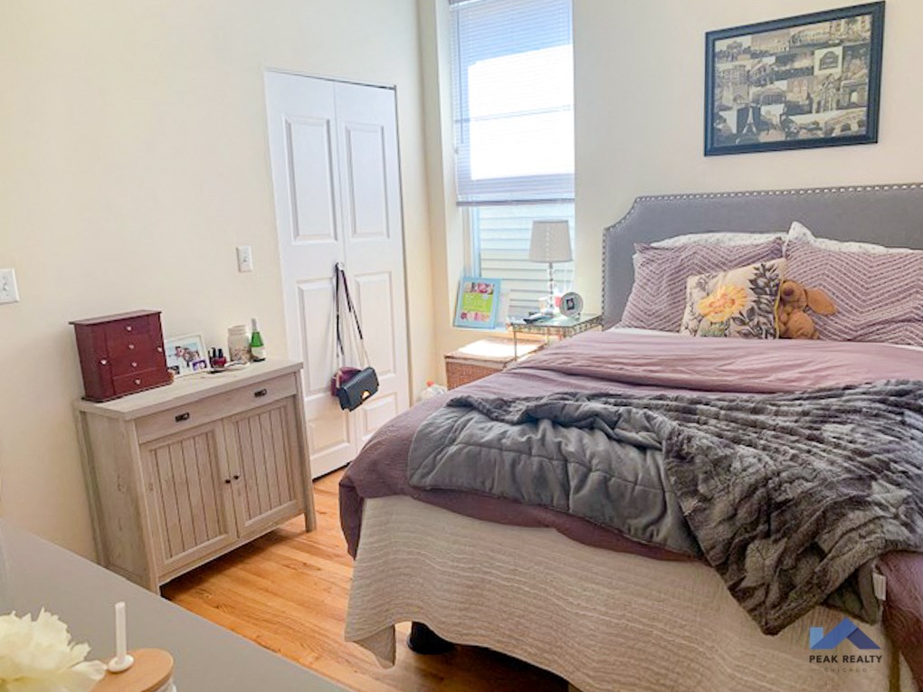 a bedroom with a bed and a dresser and a window