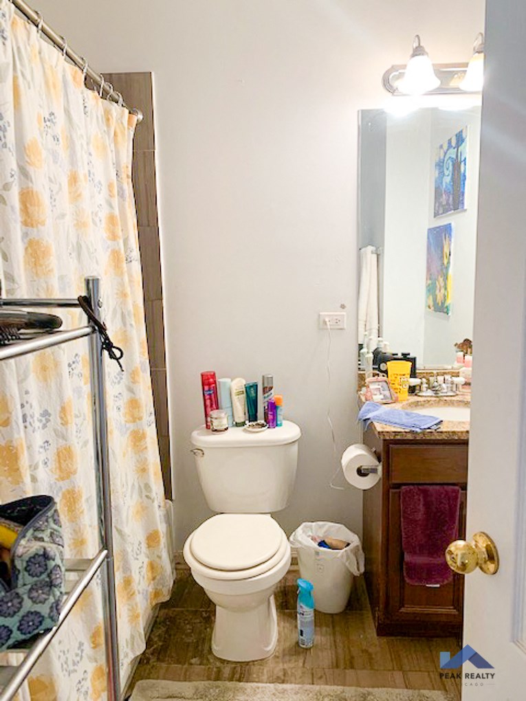 a bathroom with a toilet and a shower and a sink
