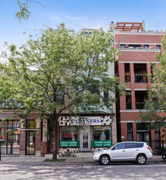 a white car parked in front of a building